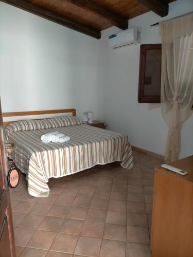 a bedroom with a bed in a room at Villaggio Athragon in Capo Vaticano