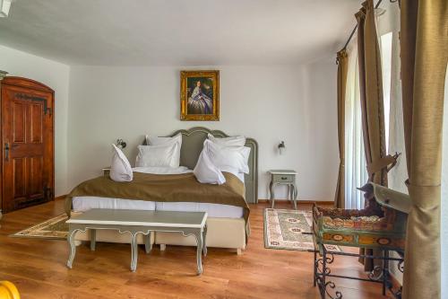 a bedroom with a bed and a table in it at Taschler Haus in Sighişoara