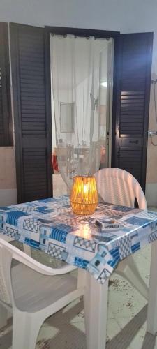 a table with a lamp on top of it at casa al mare kalispera in Marina di Mancaversa
