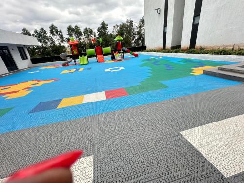 a painting of a pool with a playground at TheEJResidence- 2Bedroom All Ensuite- 7km from JKIA 3km from SGR and Expressway along Mombasa Road-Nairobi Kenya in Nairobi