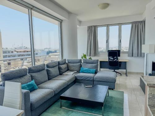 a living room with a couch and a table at Sea View City Beach Apartment in Larnaka