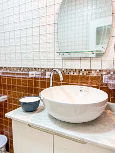 a bathroom with a white sink and a mirror at Appart-hôtel Costa Azul - Cannes in Oued Laou