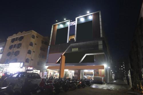 a group of motorcycles parked in front of a building at night at Super Hotel O THE FERN SUITES in Hyderabad