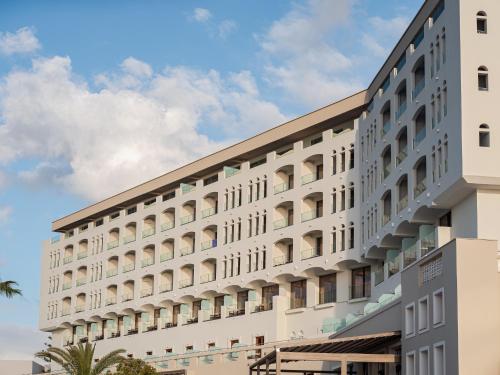 a large white building with many windows at Creta Star Hotel - Adults Only in Skaleta