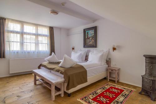 a bedroom with a large bed with white pillows at Taschler Haus in Sighişoara