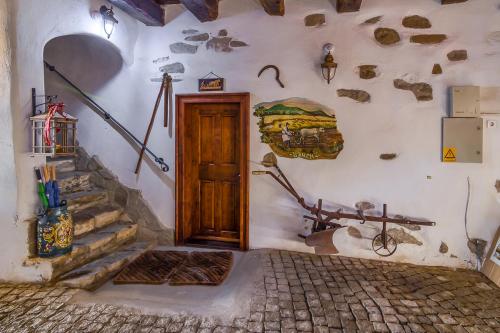a room with a door and stairs in a building at Taschler Haus in Sighişoara