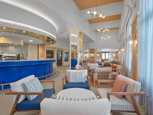 a lobby of a restaurant with chairs and a bar at Creta Star Hotel - Adults Only in Skaleta