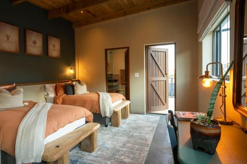 a bedroom with two beds and a mirror at Hideaways Cape Point Hideaway in Cape Town
