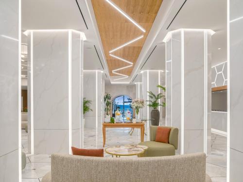 a lobby with two chairs and a table at Creta Star Hotel - Adults Only in Skaleta