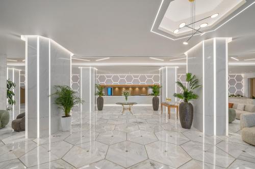 a rendering of a lobby with white walls and potted plants at Creta Star Hotel - Adults Only in Skaleta