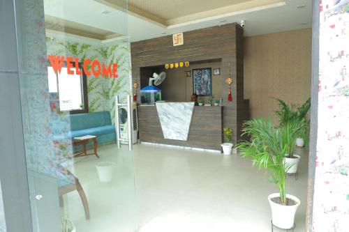 a lobby with a waiting room with a blue couch at Hotel Shri Bhaskar in Bareilly