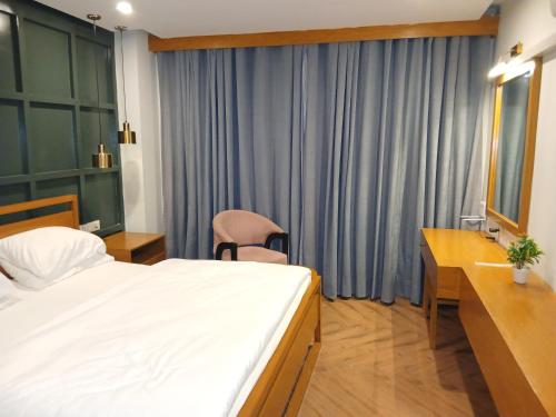 a hotel room with a bed and a sink at Grande apartments 205,206 in Rawalpindi