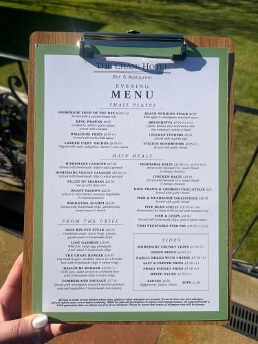 a person holding a menu in their hand at Chase Hotel in Whitehaven