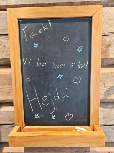 a chalkboard with the words hello written on it at Röjeråsen stugan in Röjeråsen