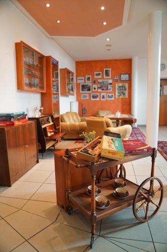 a living room with a table in a room at Hotel Sonnenhof - Tante ALMA`s Sommerfrische in Sonnen