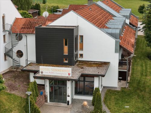 an aerial view of a house with a roof at Hotel Sonnenhof - Tante ALMA`s Sommerfrische in Sonnen