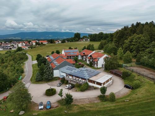 an aerial view of a house in a field at Hotel Sonnenhof - Tante ALMA`s Sommerfrische in Sonnen
