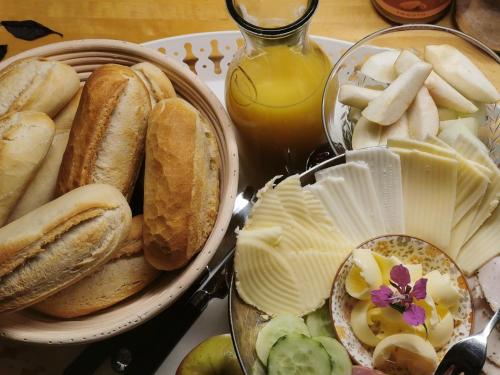 a table with a plate of bread and other foods at Kylstad Bed and Breakfast in Kylstad