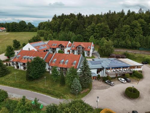 an aerial view of a large house with red roofs at Hotel Sonnenhof - Tante ALMA`s Sommerfrische in Sonnen