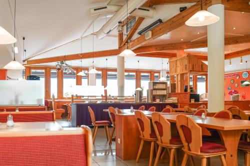 a dining room with tables and chairs in a restaurant at Hotel Sonnenhof - Tante ALMA`s Sommerfrische in Sonnen