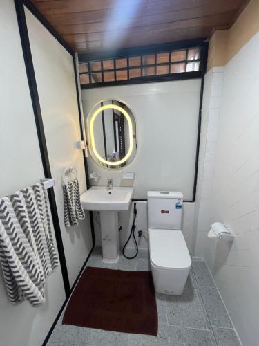 a small bathroom with a toilet and a sink at Airport waterfront chalet in Katunayake