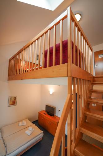 a room with a bunk bed and a staircase at Hotel Sonnenhof - Tante ALMA`s Sommerfrische in Sonnen