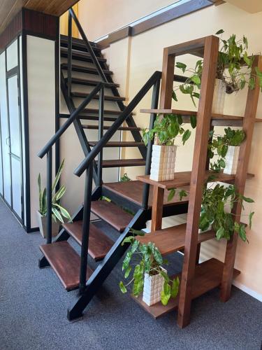 a spiral staircase with potted plants on it at Airport waterfront chalet in Katunayake