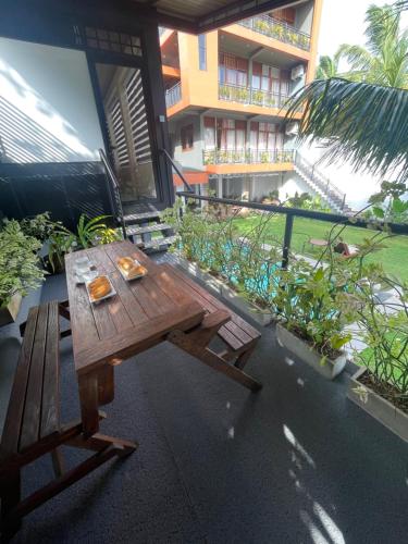 a wooden picnic table on the patio of a building at Airport waterfront chalet in Katunayake