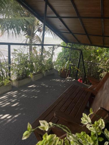 a wooden bench sitting on top of a balcony at Airport waterfront chalet in Katunayake