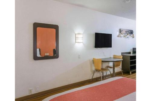a room with a table and a mirror on the wall at Motel 6-Yuma, AZ - East in Yuma