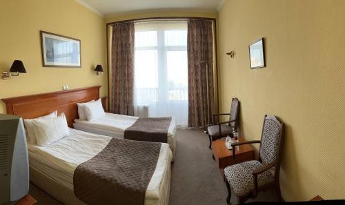 a hotel room with two beds and a television at Готель Дніпро in Kyiv