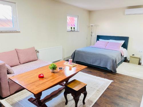 a living room with a bed and a coffee table at Guest House Bosnian House in Sarajevo