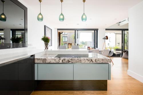a kitchen with a marble counter top and a living room at Howard Lodge BV27 Silverlake Dorset in Warmwell