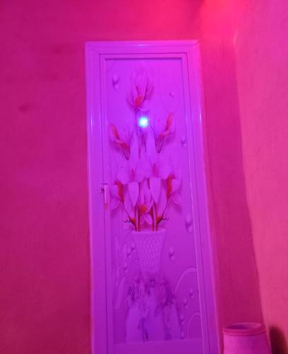 a purple door with a vase with flowers in it at Saqqara tent in Cairo