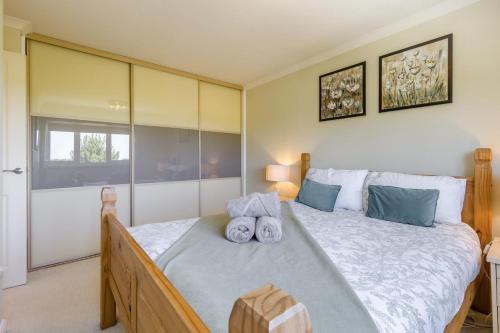a bedroom with a large bed with towels on it at 3 Bed in Baconsthorpe oc-s32338 in Baconsthorpe