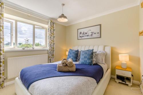 a bedroom with a large bed with a towel on it at 3 Bed in Baconsthorpe oc-s32338 in Baconsthorpe