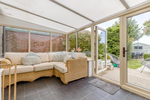 a screened in porch with a couch and windows at 3 Bed in Baconsthorpe oc-s32338 in Baconsthorpe