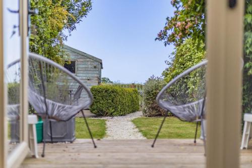 a couple of metal chairs sitting on a porch at 3 Bed in Baconsthorpe oc-s32338 in Baconsthorpe