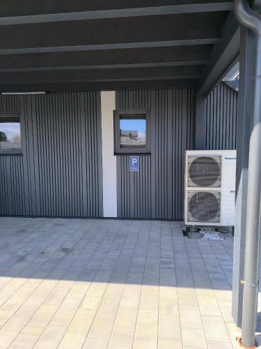 an empty garage with a fan and a building at Stadt und See Nahes Appartment in Klagenfurt