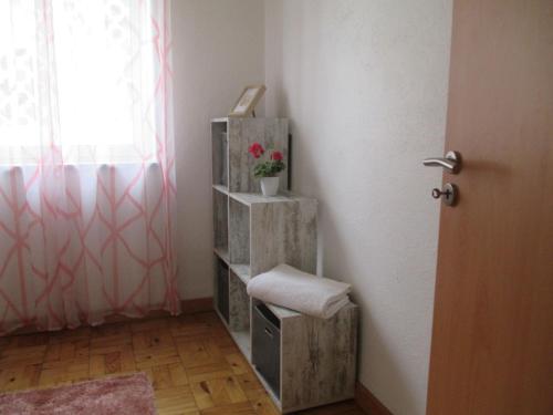 a room with a wooden shelf with a plant on it at Casa dos avós in Canas de Senhorim
