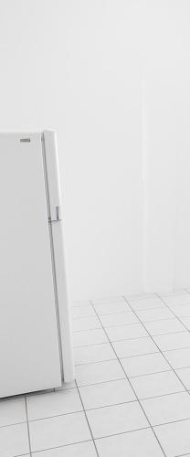 a white refrigerator in a room with white tile floors at Departamento Puerto Vallarta in Puerto Vallarta