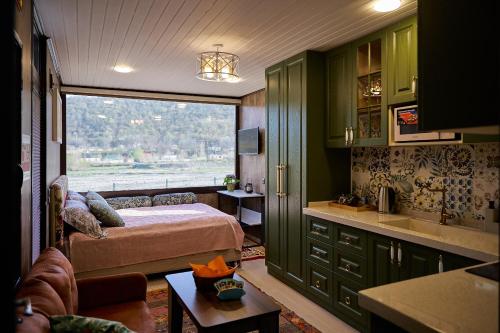 a bedroom with a bed and a large window at Villa Marusya Qusar in Qusar