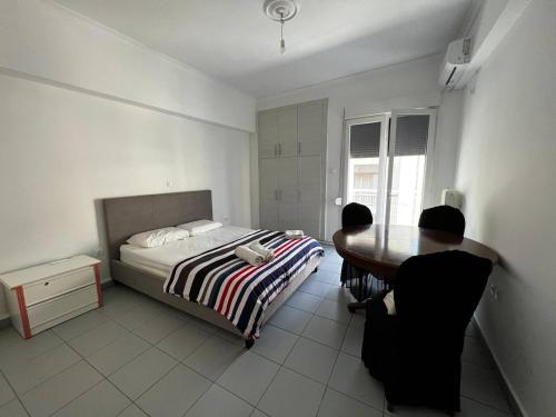 two people sitting at a table in a bedroom at Kipseli Rooms in Athens