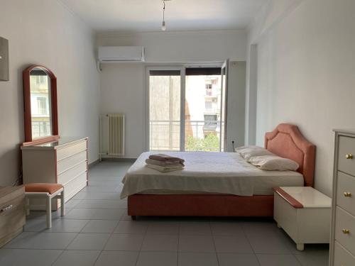 a bedroom with a bed and a dresser and a window at Kipseli Rooms in Athens