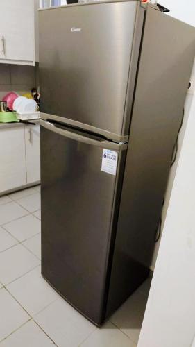 a stainless steel refrigerator in a kitchen at Kipseli Rooms in Athens