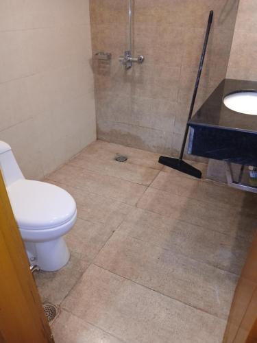 a bathroom with a toilet and a shower and a sink at Grande apartments 205,206 in Rawalpindi