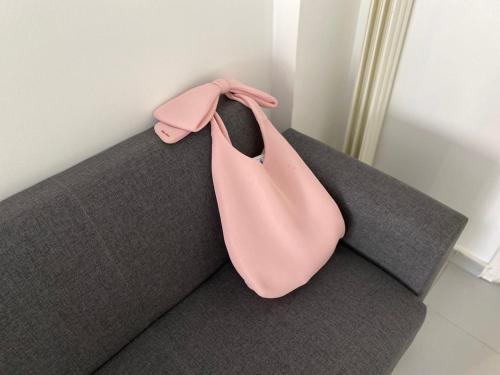 a pink tie sitting on top of a couch at Kipseli Rooms in Athens