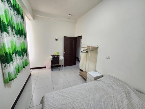a white room with a bed and a desk at 谷香 Guxiang House 東區靜巷透天獨棟 in Tainan