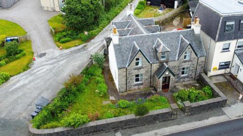 an aerial view of a large house with a yard at Blairmore House in Broadford