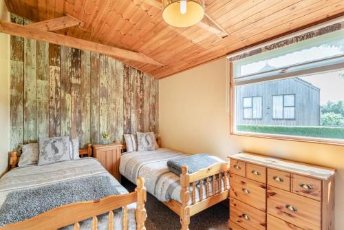 a bedroom with two beds and a window at 2 Bed in Keddington oc-t32411 in Louth
